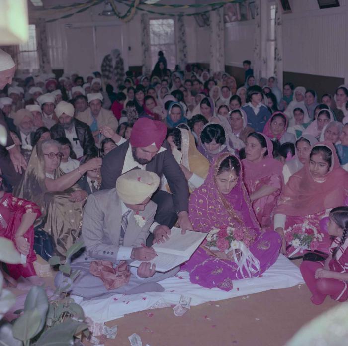 [Group photo of Vern Thind and Rupinder Mann with wedding guests]