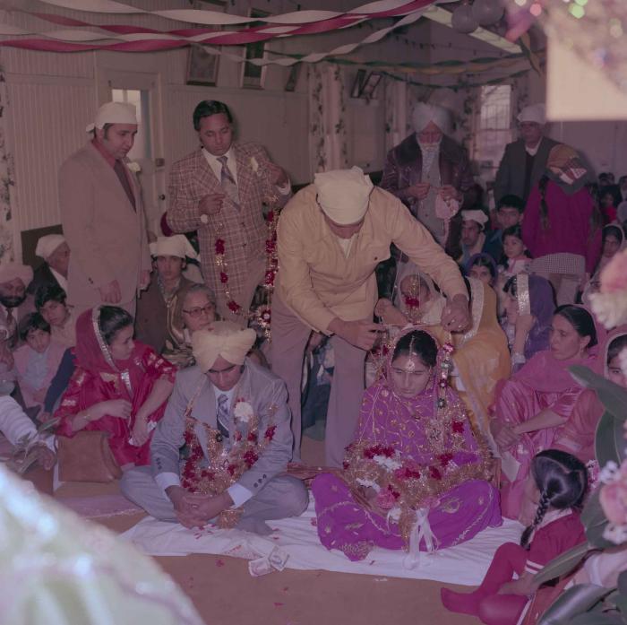 [Group photo of Vern Thind and Rupinder Mann with wedding guests]