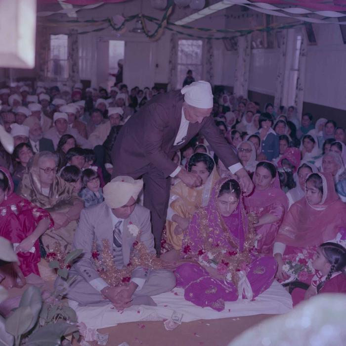 [Group photo of Vern Thind and Rupinder Mann with wedding guests]
