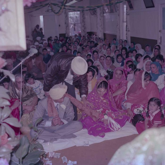 [Group photo of Vern Thind and Rupinder Mann with wedding guests]