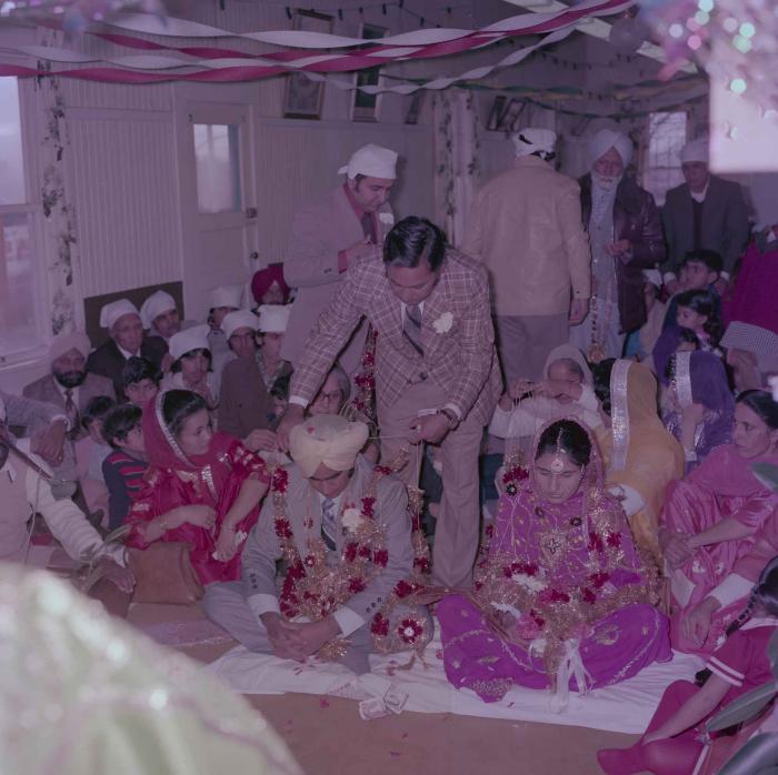 [Group photo of Vern Thind and Rupinder Mann with wedding guests]