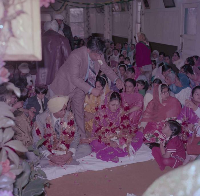 [Group photo of Vern Thind and Rupinder Mann with wedding guests]
