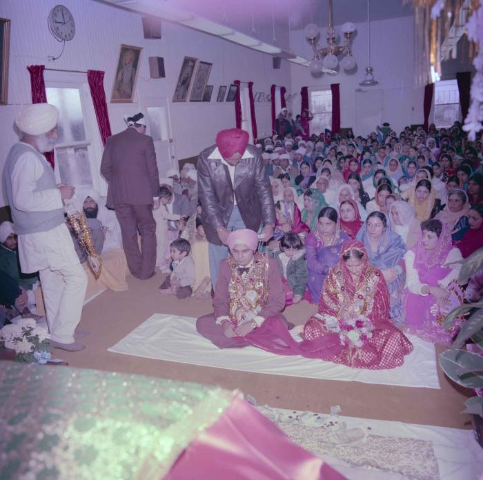 [Group photo of Parminder Tiwana and Kataro Gill with wedding guests]