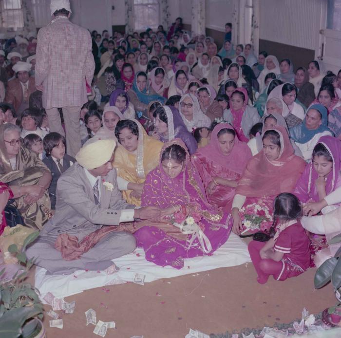 [Group photo of Vern Thind and Rupinder Mann with wedding guests]