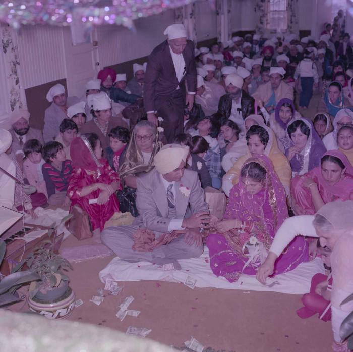 [Group photo of Vern Thind and Rupinder Mann with wedding guests]