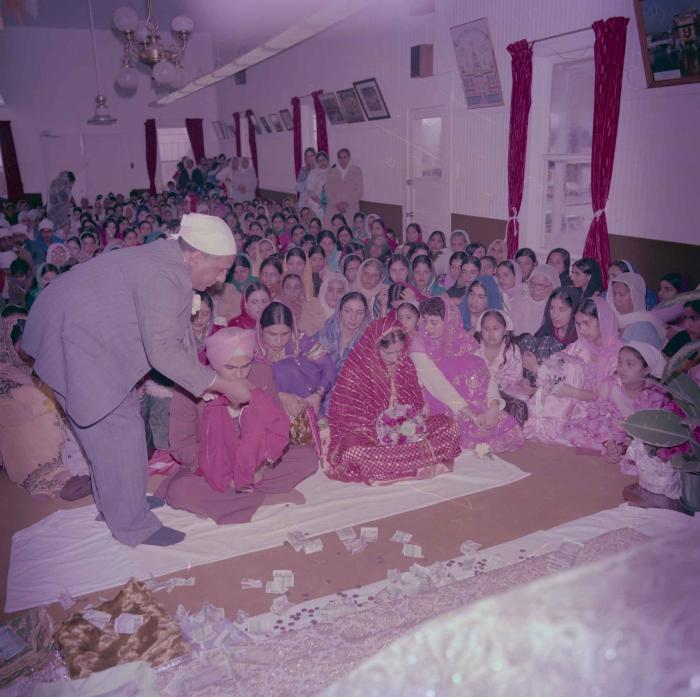 [Group photo of Parminder Tiwana and Kataro Gill with wedding guests]