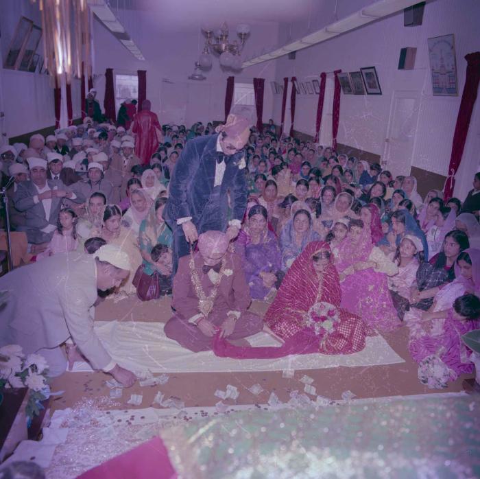 [Group photo of Parminder Tiwana and Kataro Gill with wedding guests]