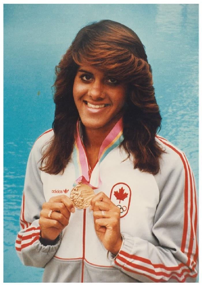 [Photo of Pamela Rai wearing her Olympic bronze medal won in 1984 Olymics]