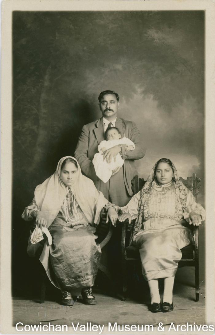 [Ganda Singh holding a baby and posing with his wife and Mayo's wife Bishan Kour]