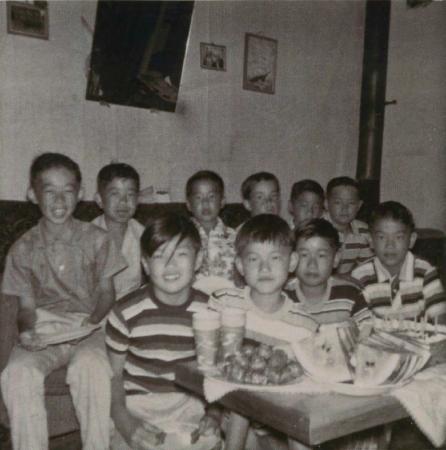 [Photo of a Dick Yano and friends inside a house]