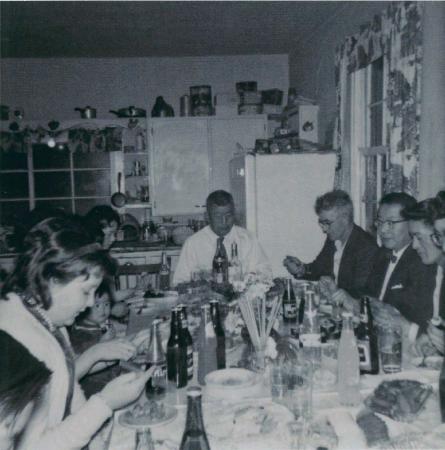 [Photo of a group of people in a kitchen]