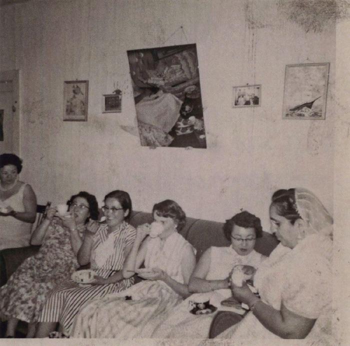 [Photo of a group of women sitting on a sofa]