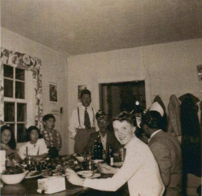 [Photo of a group of people at a dining table]