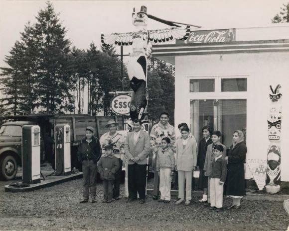 [Photo of Bal Singh and Shanti Devi Mayer family in front of a gas station]