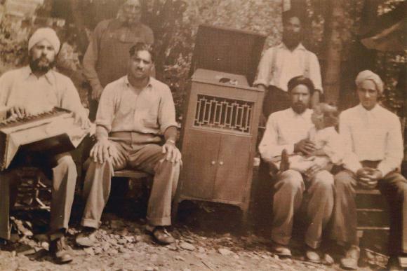 [Photo of a group of men with music instruments]