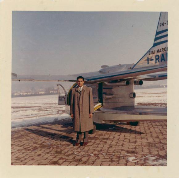 [Photo of Rajindi Mayo in front of an airplane]