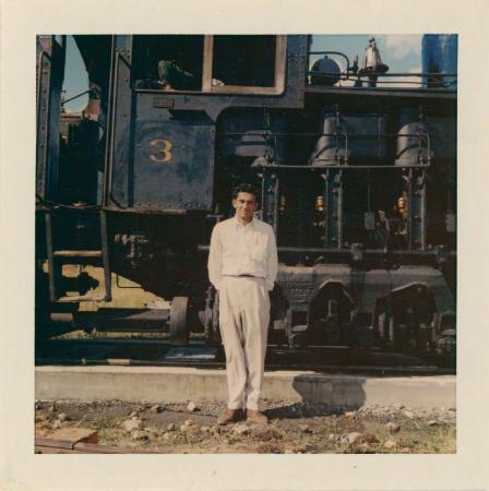 [Photo of Karnail Singh Saroya standing in front of a steam engine]