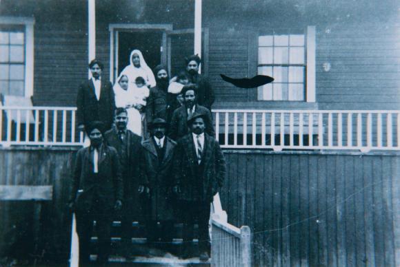 [Photo of a group of people standing outside Paldi Gurdwara]