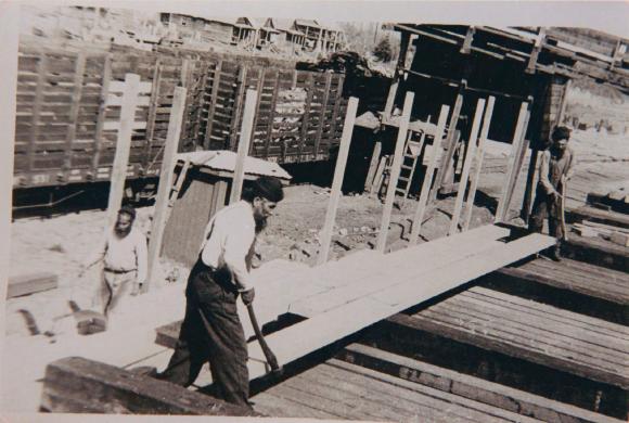[Photo of two Sikh men on the timber deck at Mayo Lumber Mill in Paldi, B.C.]