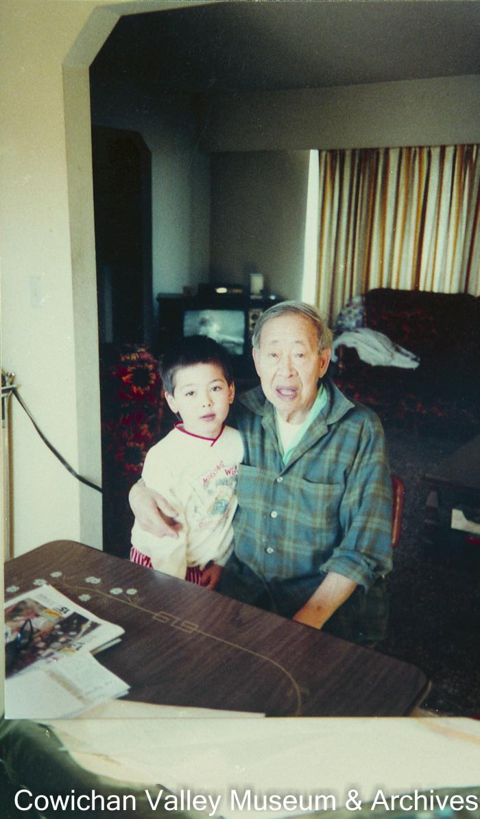 Lum Buck Chew with his grandson, at home in Nanaimo