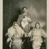 [Ganda Singh holding a baby and posing with his wife and Mayo's wife Bishan Kour]