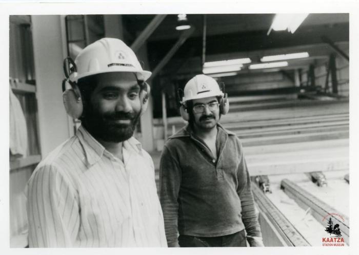 [Photo of lumber graders Gurdial Parmar and Buta Manhas at Mayo Lumber in Nanaimo, B.C.]