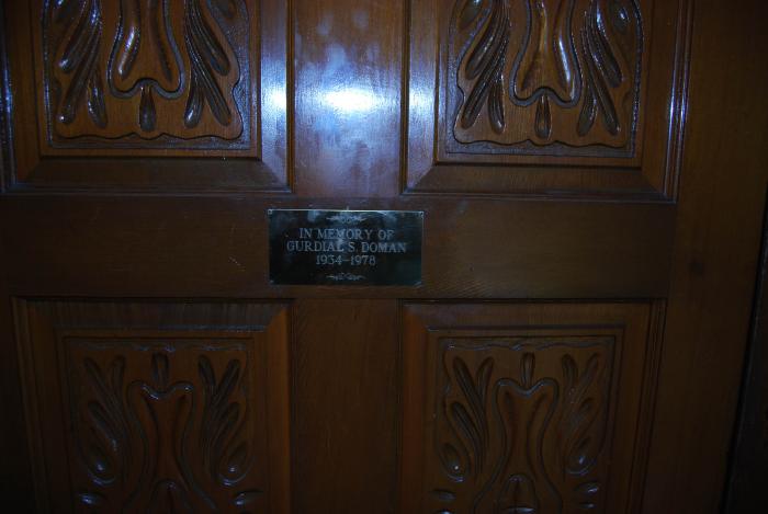[Photo of door with sign reading "In memory of Gurdial S. Doman 1934-1978]