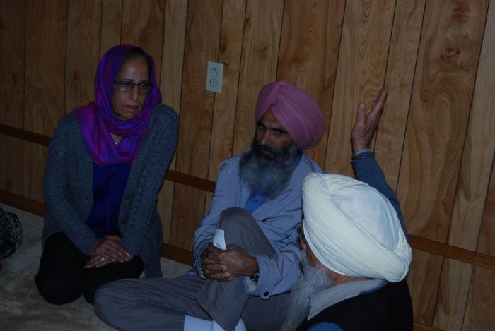 [Photo of Satwinder Bains with Amarjit Singh Heer and an unidentified man]