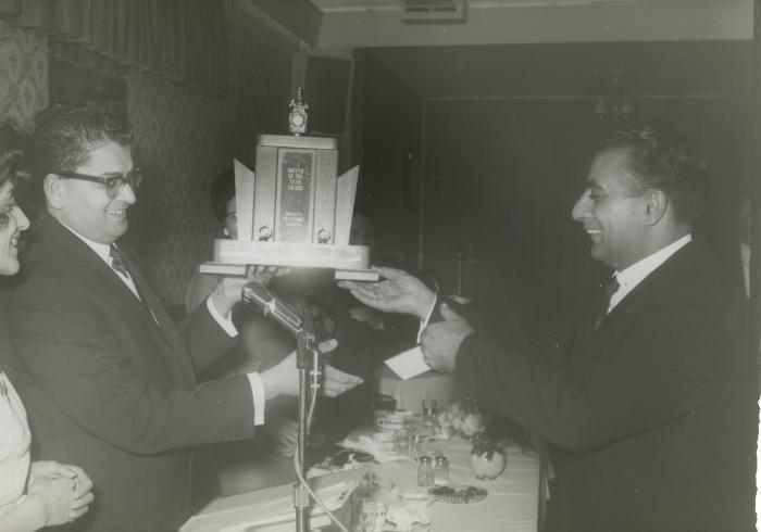 [Photo of Herb Doman presenting a trophy to Doman's Transport Limited's driver of the year 1965]