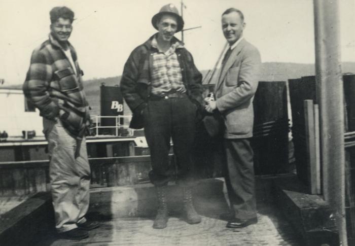 [Group photo of Herb Doman and two unidentified men standing at a dock]
