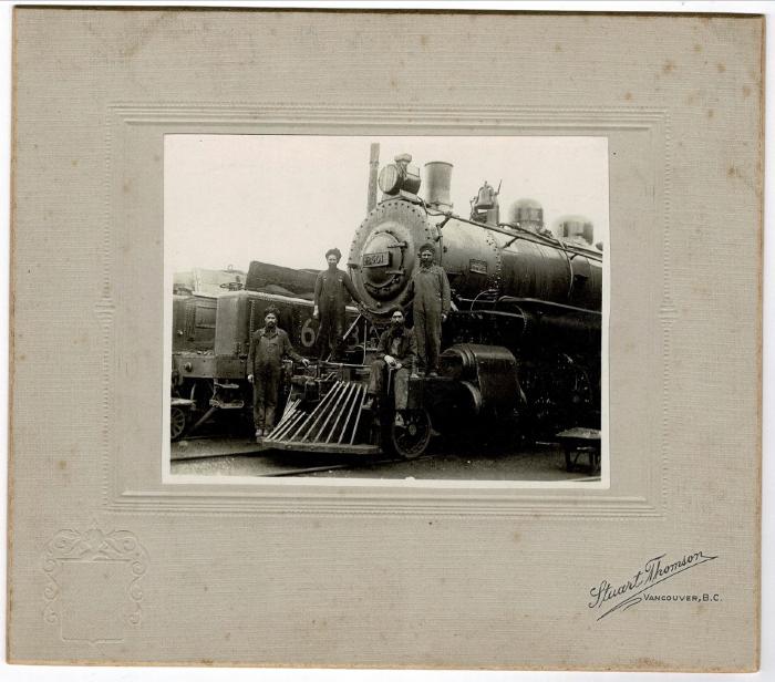 [Photo of Hakam Singh Hundal with three unidentified men on a locomotive, Vancouver, B.C.]