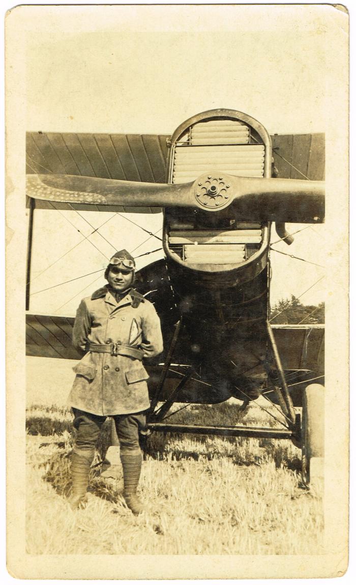 [Photo of Ikball Singh Hundal in Reserve Officer Training Corps uniform in front of an aircraft]