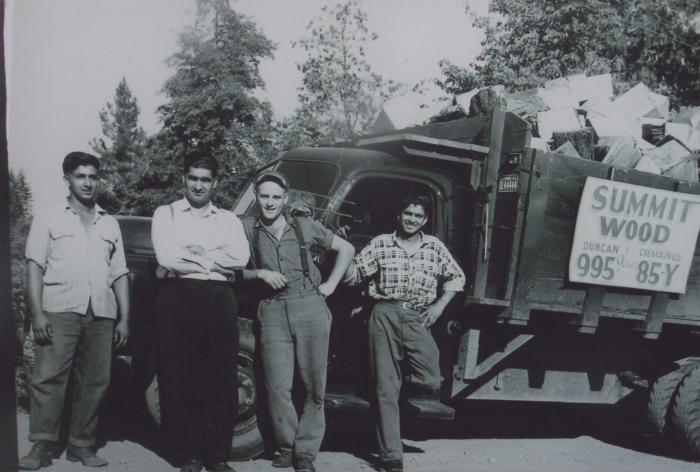 [Group photo of four transport workers with a Summit Wood hauling truck]
