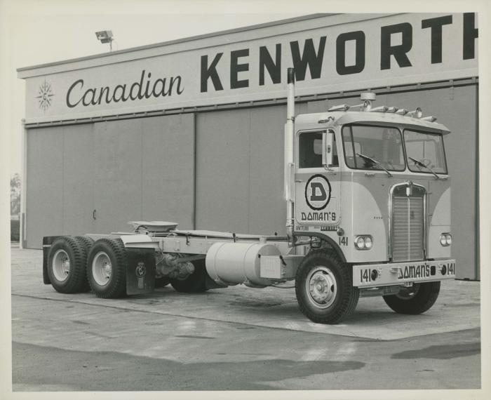 [Photo of Doman Industries transport truck no. 141 at a Canadian Kenworth building]