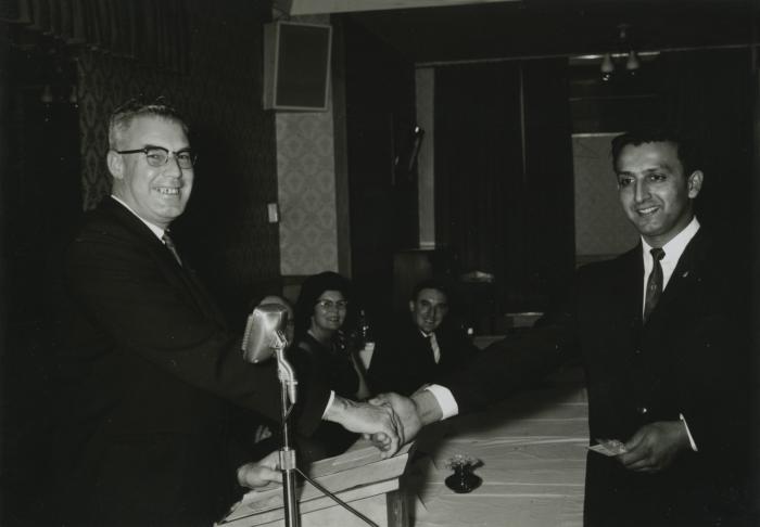 [Photo of an unidentified higher-up shaking hands with Doman's Transport Limited's driver of the year 1965]