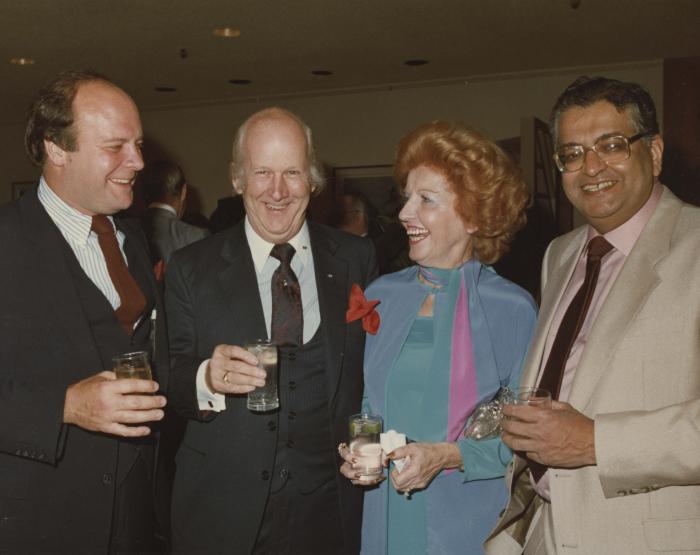 [Group photo of Herb Doman, Grace McCarthy, Ray McCarthy, and an unidentified man mid-conversation at an unidentified party]