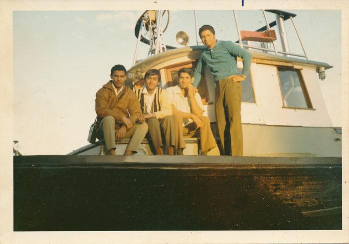 [Group photo of Rajinder Singh Gill on a sawmill logging boat]