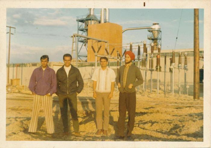 [Group photo of Rajinder Singh Gill in front of a mill]