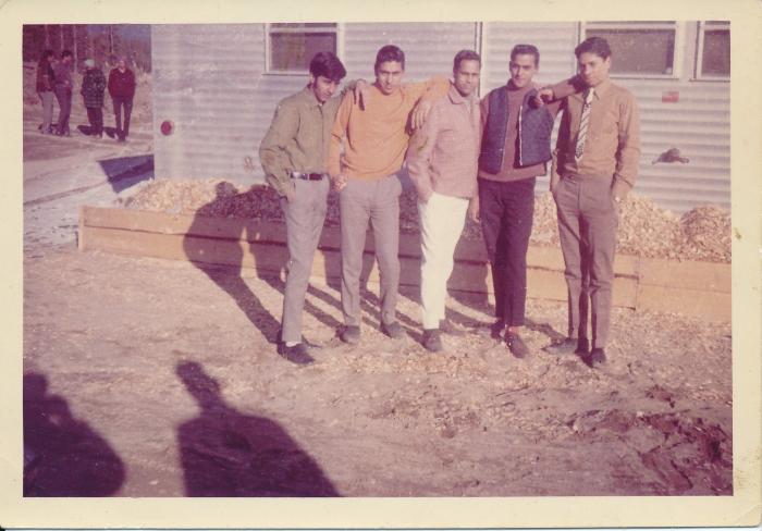 [Group photo of Rajinder Singh Gill in front of McKenzie bunkhouse]