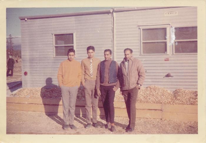 [Group photo of Rajinder Singh Gill in front of McKenzie bunkhouse]
