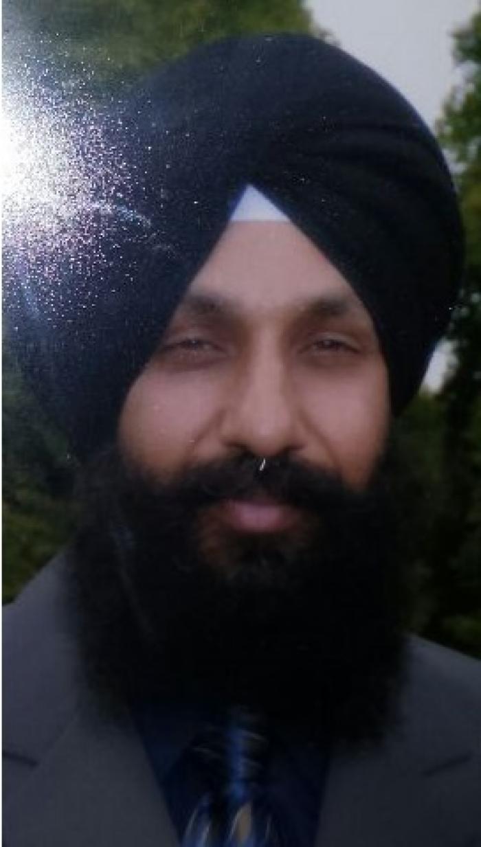 [Photo of Surinder Singh]