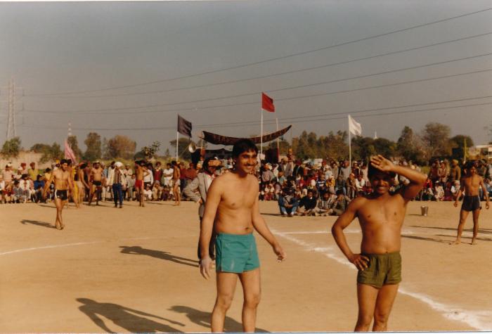 [Group photo of Sukhwinder Bolla playing kabbadi with other unidentified men]