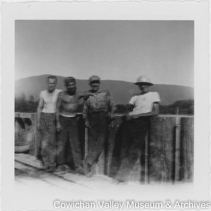 [Four unidentified workers on bridge]