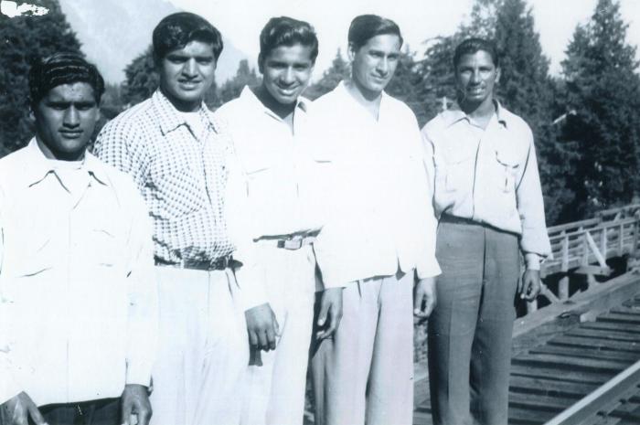 [Photo of five South Asian men]