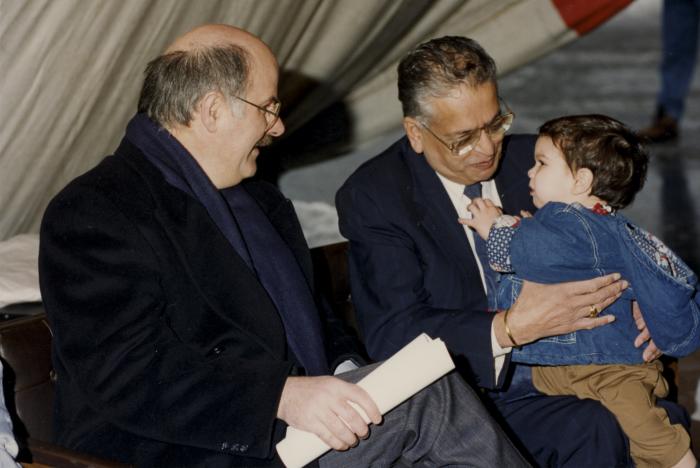 [Photo of Herb Doman, Mike Harcourt and an unidentified child at an unidentified event in a snowy parking lot]