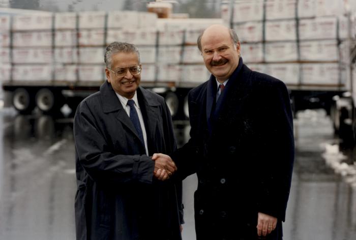 [Photo of Herb Doman and Mike Harcourt at an unidentified event in a snowy parking lot]