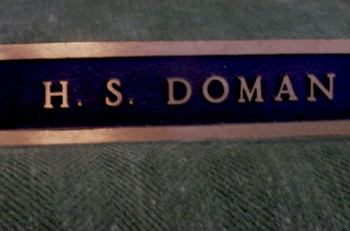 [Photo of the name plate from the desk of Herb Doman]