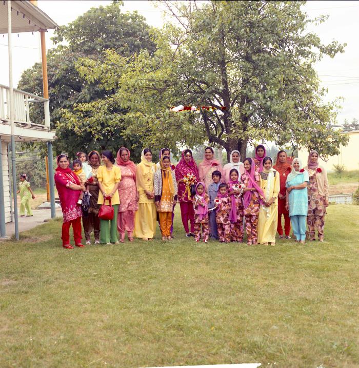 [Photo of Sharn Kingra and a group of unidentified women]