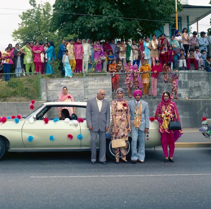 [Photo of Baldave Sidhu, Sharn Kingra and wedding guests in front of the Gur Sikh Temple in Abbotsford]