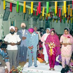 [Photo of Baldave Sidhu, Sharn Kingra and weddings guests]